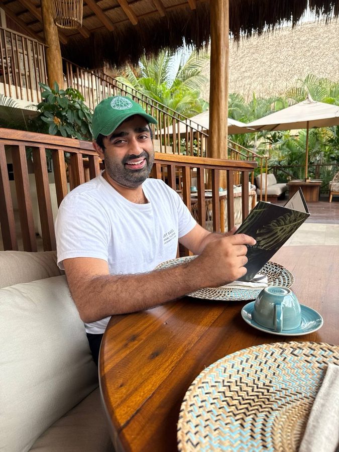 Person in a DOA hat at a tropical resort